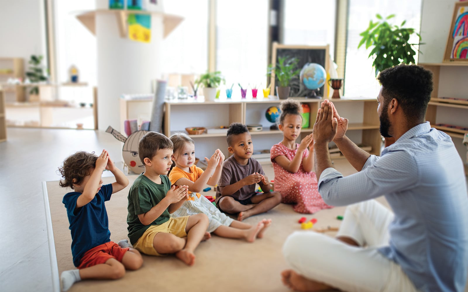 Teacher doing an activity with students in early learning classroom