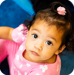 Young child looking up at the camera